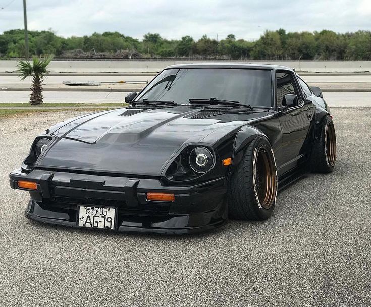 a black sports car parked in a parking lot