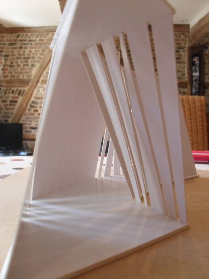 a white sculpture sitting on top of a wooden table