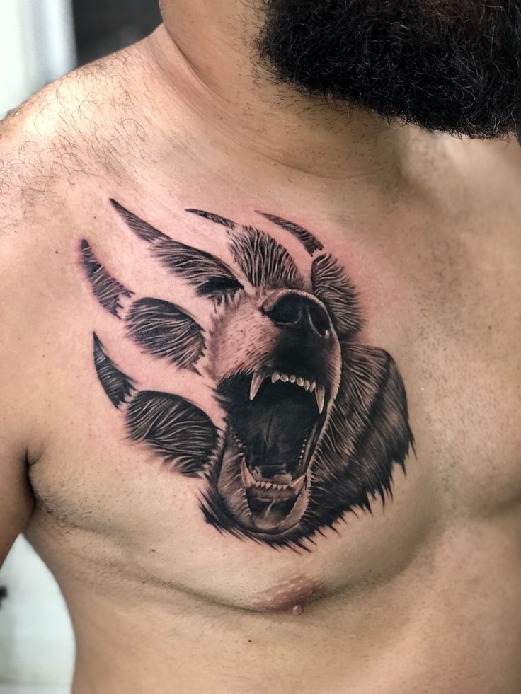 a man's chest with an angry bear tattoo on his chest and the head of a bear