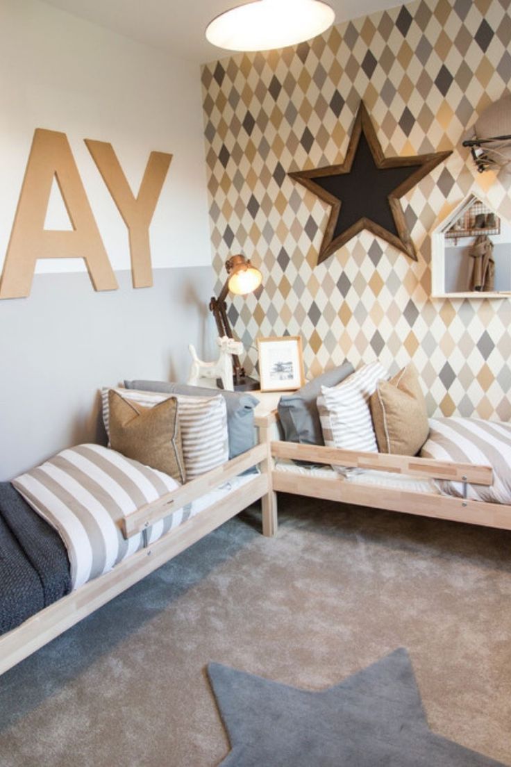 a child's room with two beds and a star on the wall