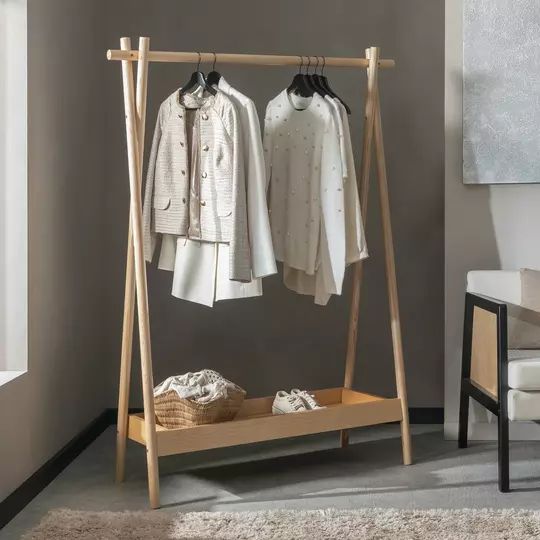 a clothes rack with two coats hanging on it