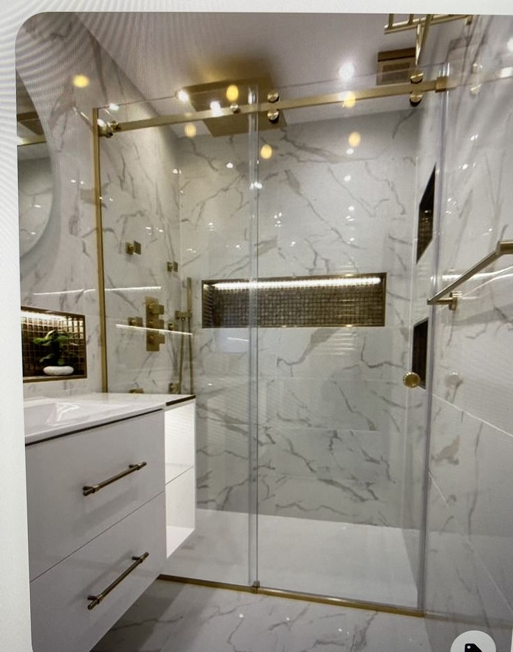 a bathroom with white marble and gold accents