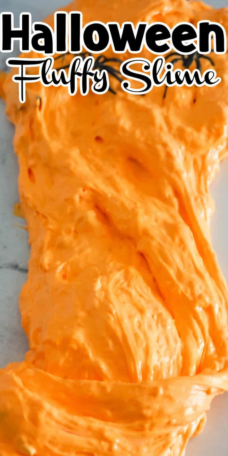 an orange slime is sitting on a white surface with the words halloween fluffy slime written above it