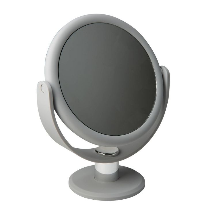 a mirror that is sitting on top of a white stand with it's reflection in the mirror