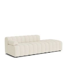 a white couch sitting on top of a white floor