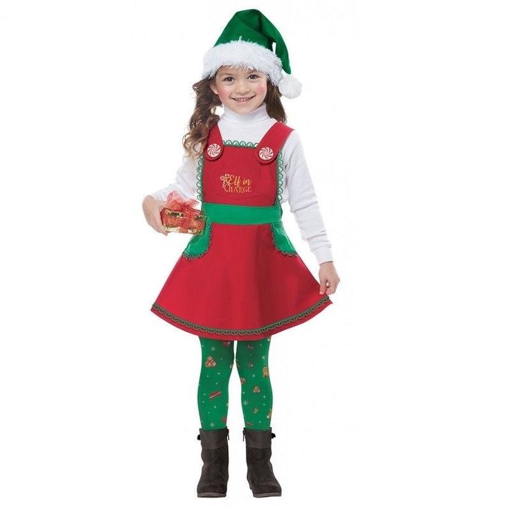 Your little one can be Santa's main helper in this Elf in Charge Child costume. This festive red elf dress comes with green accents and decorative peppermint buttons with adjustable criss-cross straps that tie into a bow at the back and a holiday hat and a pair of leggings with print. The white turtleneck shirt and footwear are not included. Available in children's sizes - Small/Medium (fits up to size 6-10) or Large/XL (fits up to size 8-12). Costumes typically run a little smaller than regular Holiday Character Outfits Christmas, White Turtleneck Shirt, Toddler Costumes Girl, Elf Dress, California Costumes, Holiday Hats, Christmas Party Outfit, Feminine Chic, Christmas Party Outfits