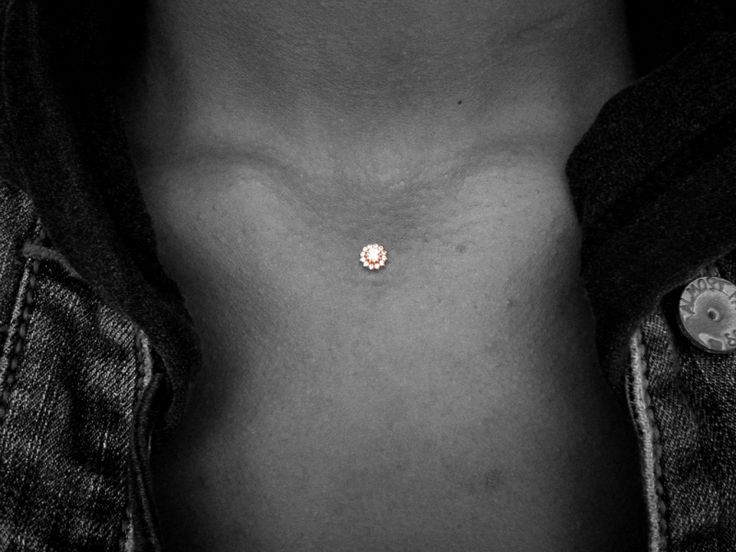 a man's chest with a small diamond in the middle of his left breast