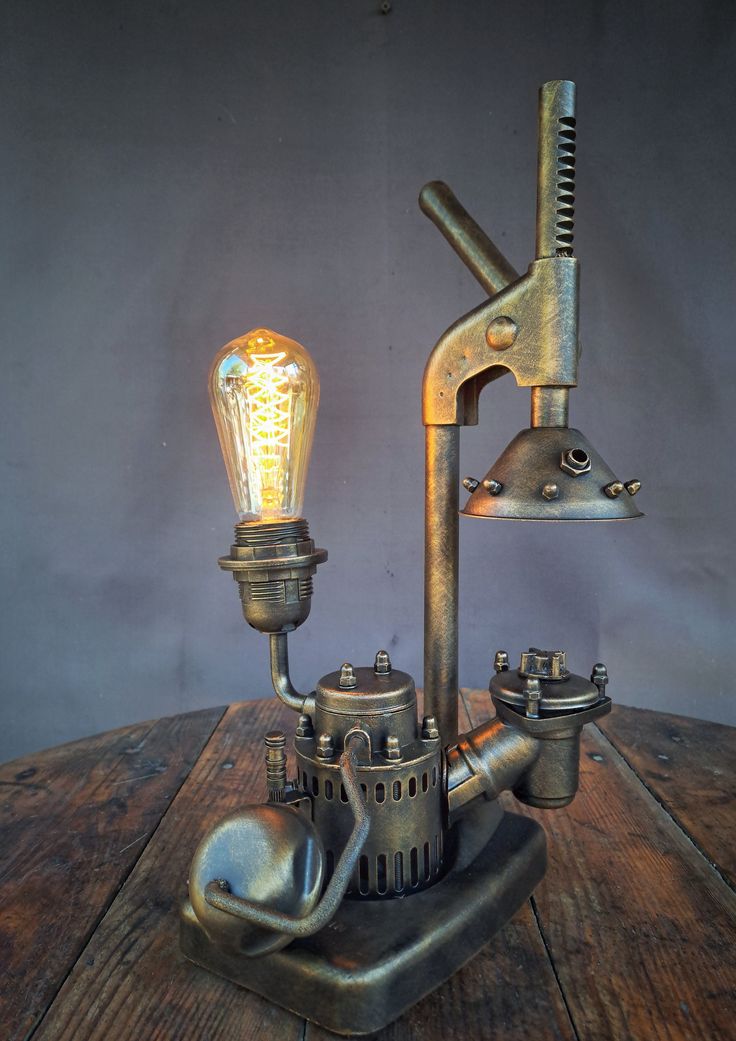 an old fashioned steam engine lamp on a wooden table