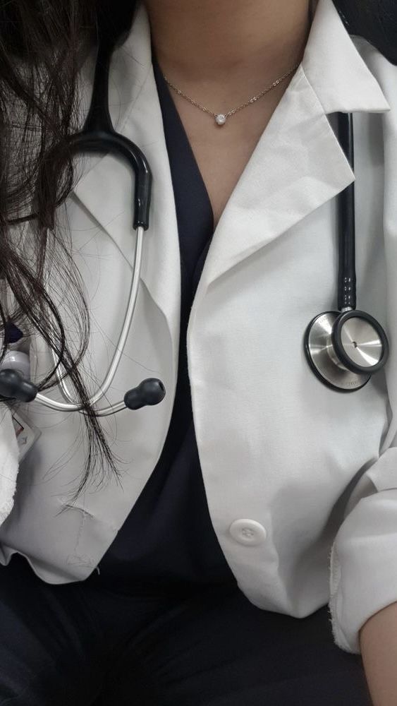 a woman wearing a white coat and stethoscope