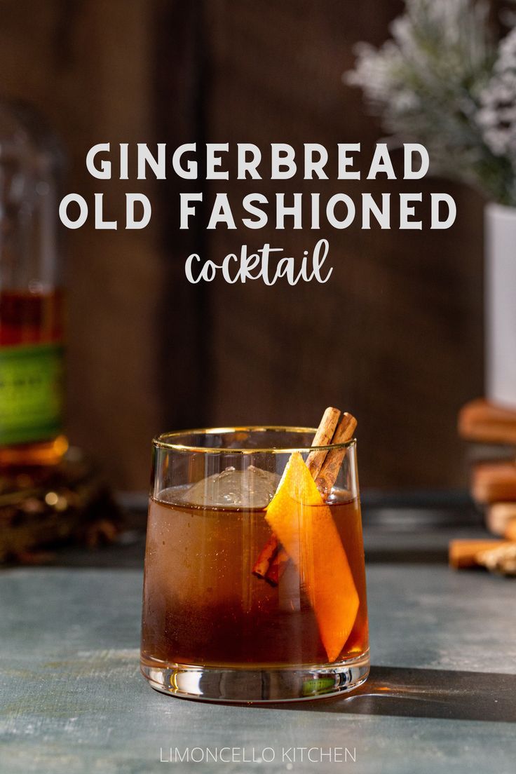 Gingerbread Old Fashioned cocktail in an old fashioned style glass. The drink is brown and has a large sphere of ice in the glass along with an orange peel and a cinnamon stick garnish. In the background to the left is a bottle of Bulleit rye whiskey, and to the right is a vase with snowy looking evergreens with a stack of wooden coasters under the vase. Text overlay above the cocktail reads “Gingerbread Old Fashioned cocktail”. Cinnamon Holiday Cocktails, Gingerbread Old Fashioned, Ginger Bread Cocktail, Gingerbread Old Fashioned Cocktail, Gingerbread Cocktail Holiday Drinks, Gingerbread Syrup Cocktail, Ginger Old Fashioned Cocktail, Winter Whiskey Drinks, Whiskey Christmas Drinks