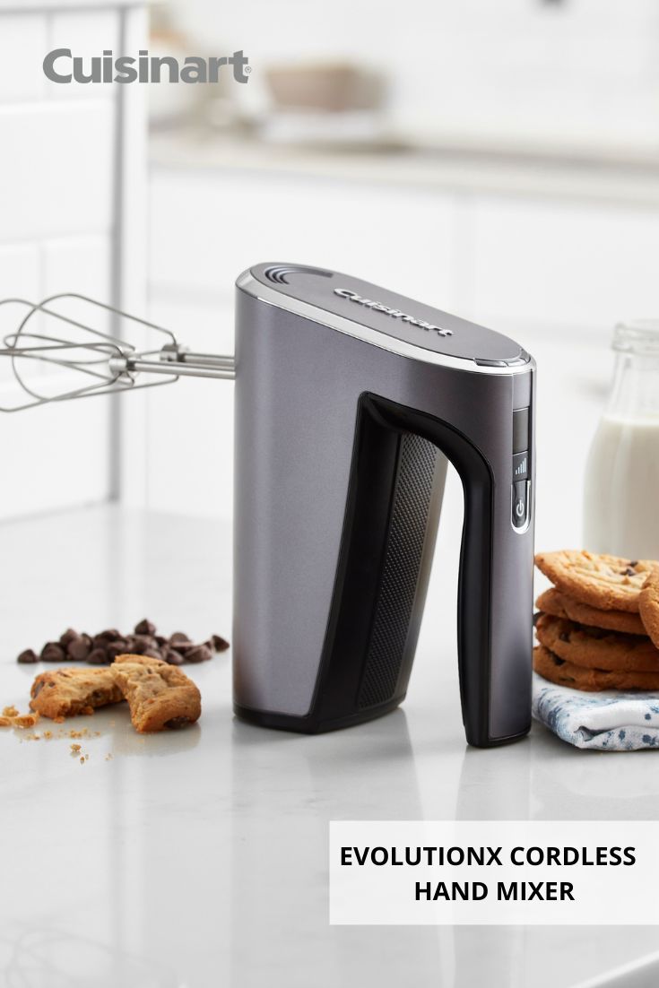 a close up of a toaster on a counter with cookies and milk in the background