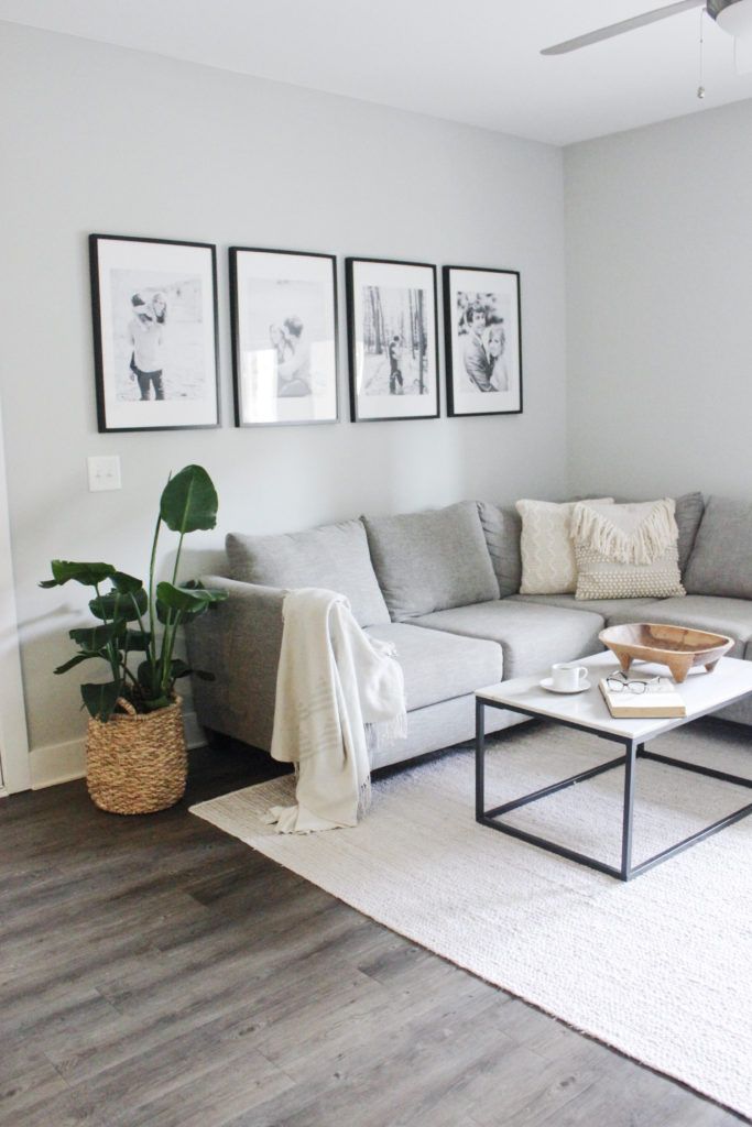 a living room filled with furniture and pictures on the wall