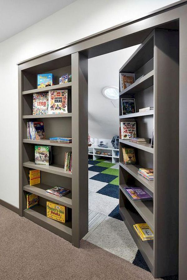 an open bookcase in the corner of a room with carpeted flooring and white walls