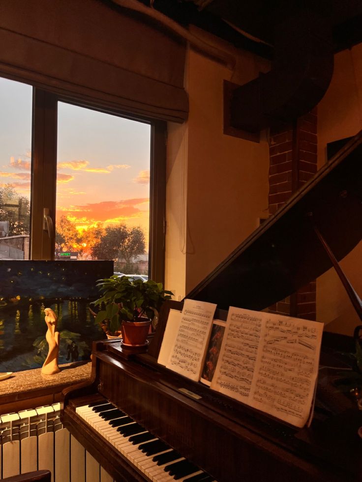 a piano sitting in front of a window