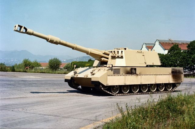 an army tank is driving down the road