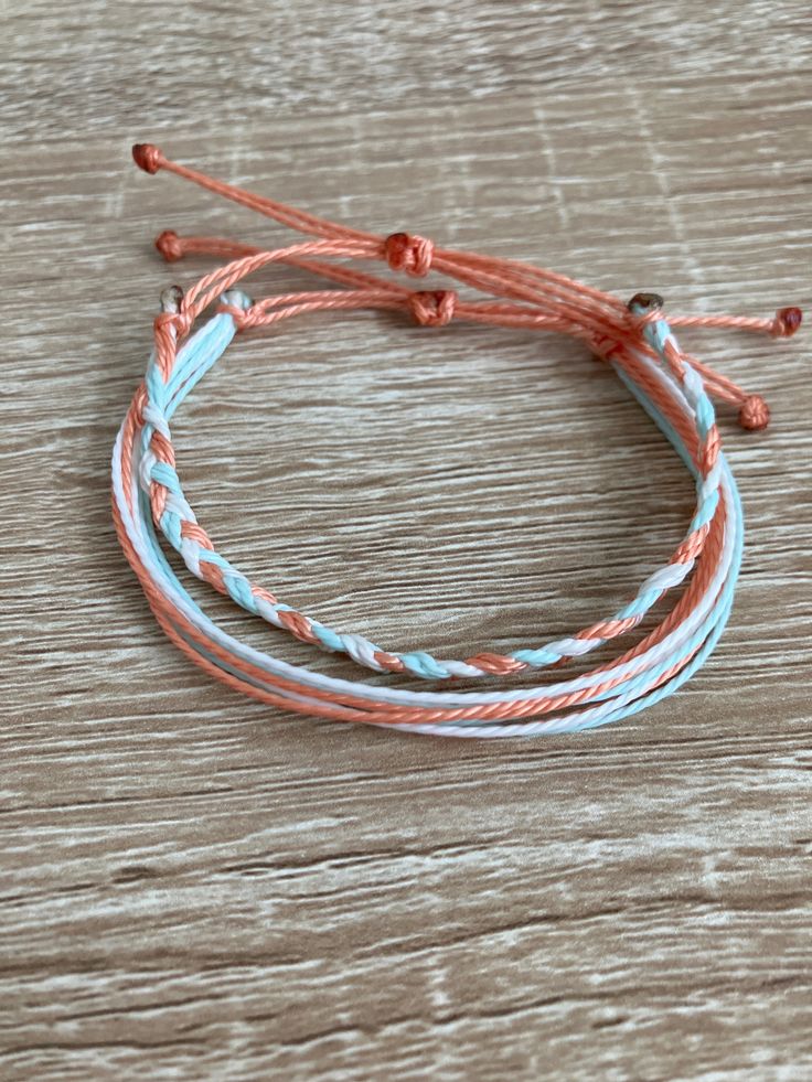 three bracelets on top of a wooden table