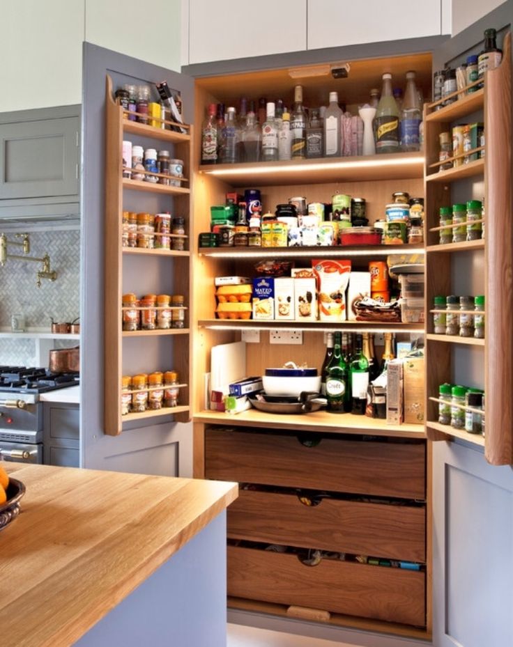 an open pantry with lots of spices and condiments on the shelves in it