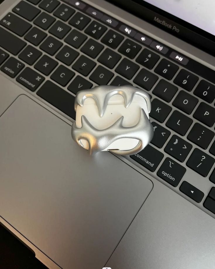 a white object sitting on top of a laptop keyboard