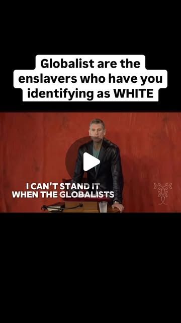 a man standing in front of a red wall with text on it that reads, globalists are the enslaverrs who have you identifying as white