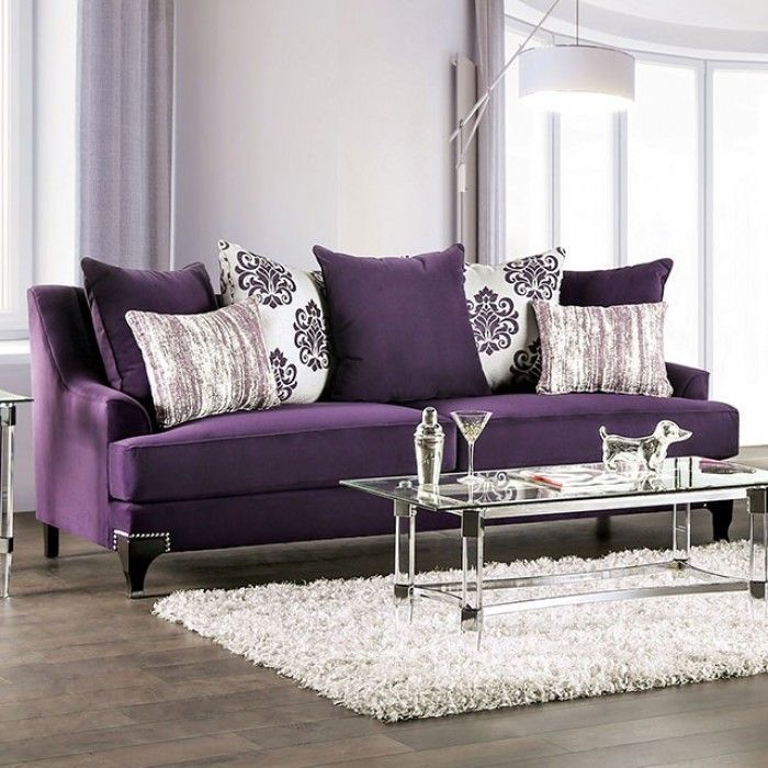 a living room with purple couches and white rugs