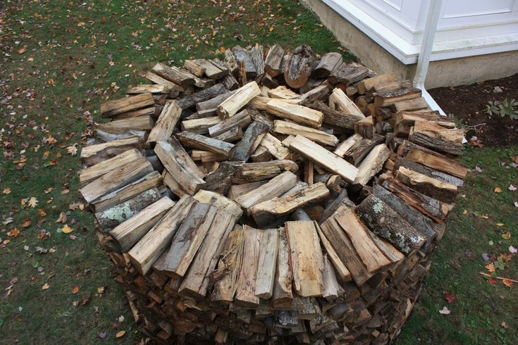 a pile of wood sitting in the grass