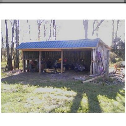 a shed with two motorcycles parked in front of it