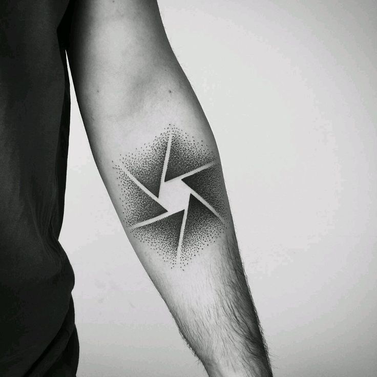 a black and white photo of a man's arm with a lightning bolt tattoo on it