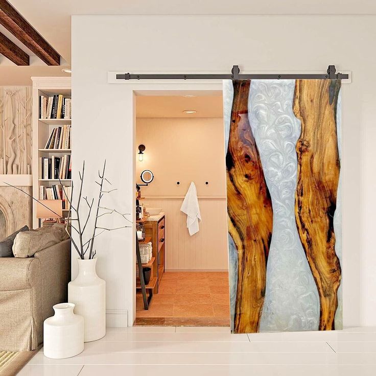 an open door to a living room with two wooden trees on the outside and inside