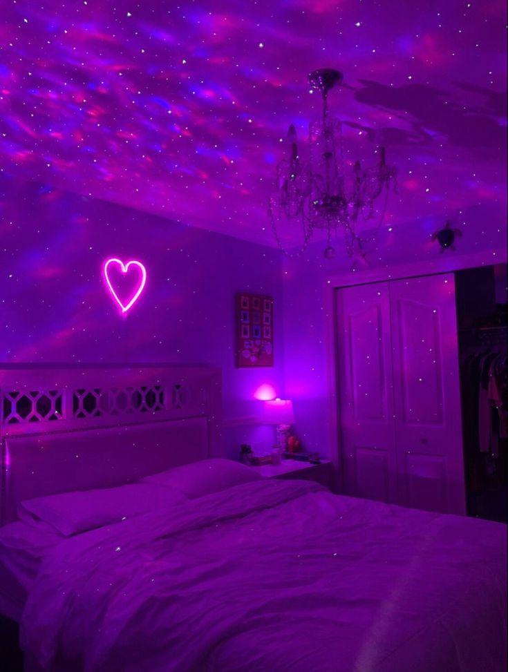 a bedroom with purple lights and a heart on the wall