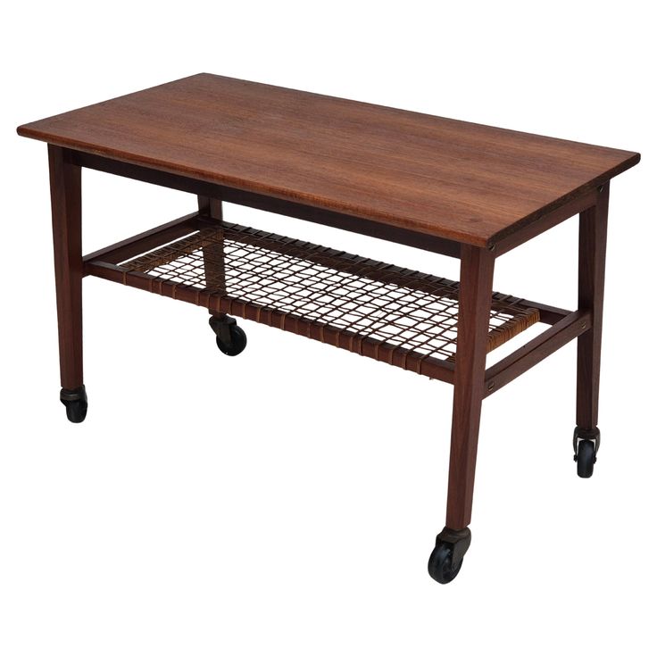 a wooden table with wheels and a shelf on the bottom that holds two trays