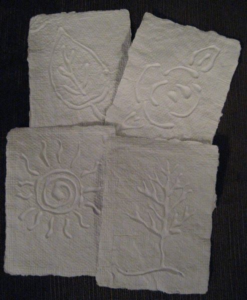 four white towels sitting on top of a table