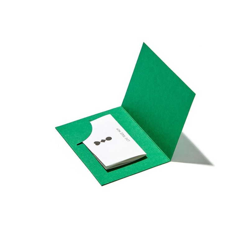 an open green folder with a notepad inside