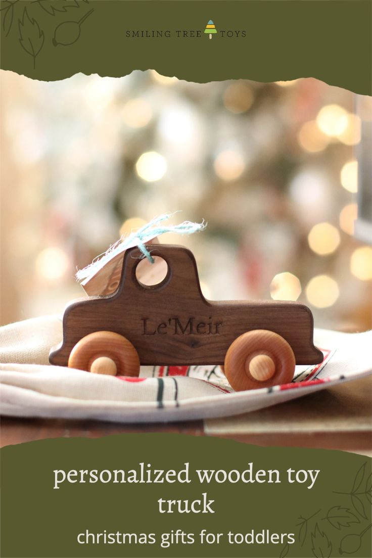 a wooden toy truck sitting on top of a white cloth covered plate with the words personalized wooden toy truck christmas gifts for toddlers