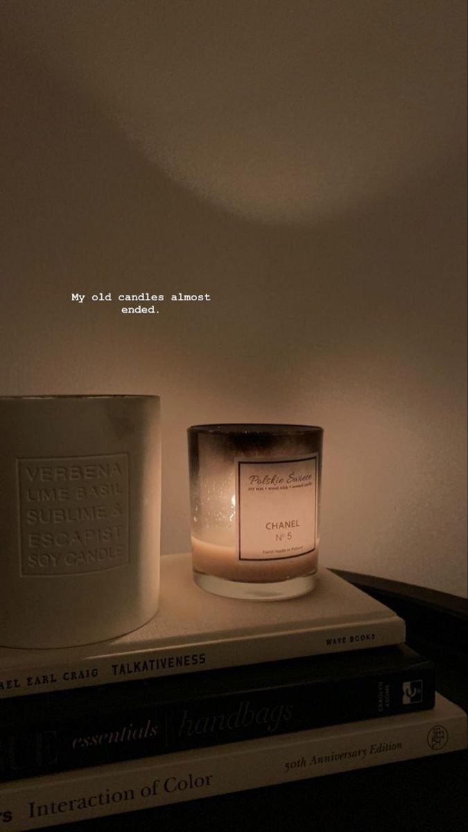 a candle and some books on a table