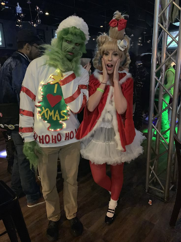 a man and woman in costumes standing next to each other