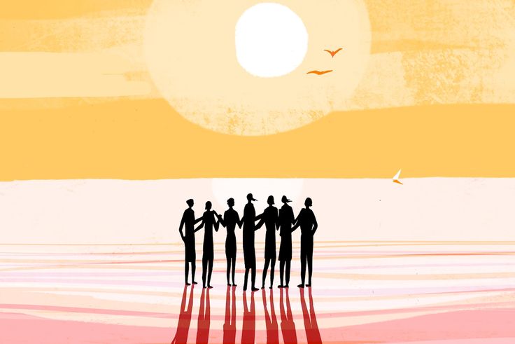 a group of people standing next to each other in front of the ocean at sunset