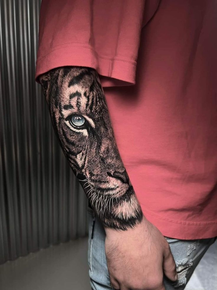 a man with a tiger tattoo on his arm