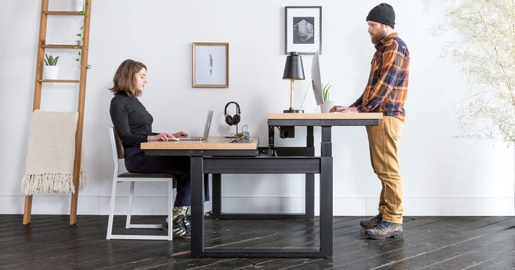 two people sitting at a table in an office