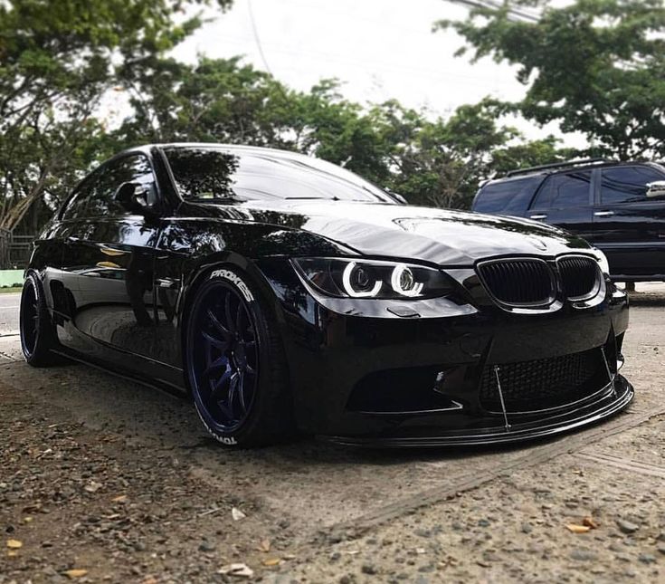 a black car is parked on the street