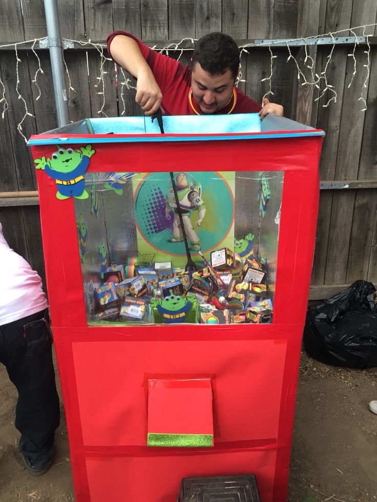 a young boy is playing with an arcade machine