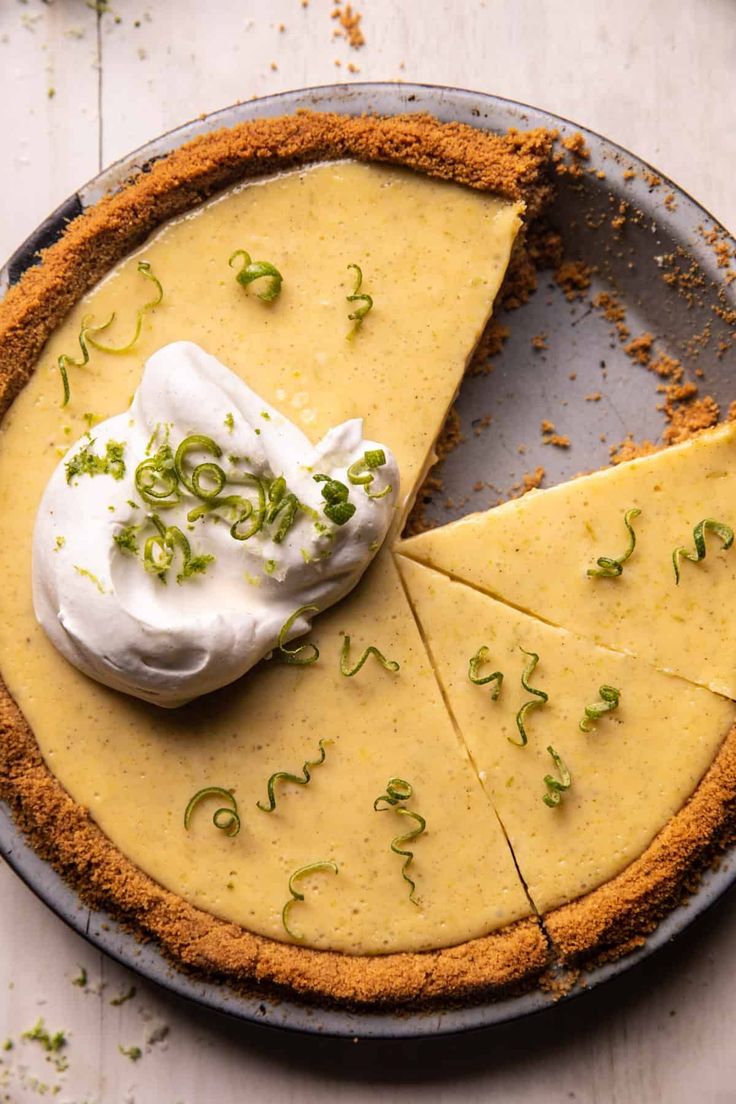 there is a pie that has been cut into slices and topped with whipped cream on top