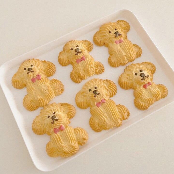 small cookies shaped like teddy bears on a white tray