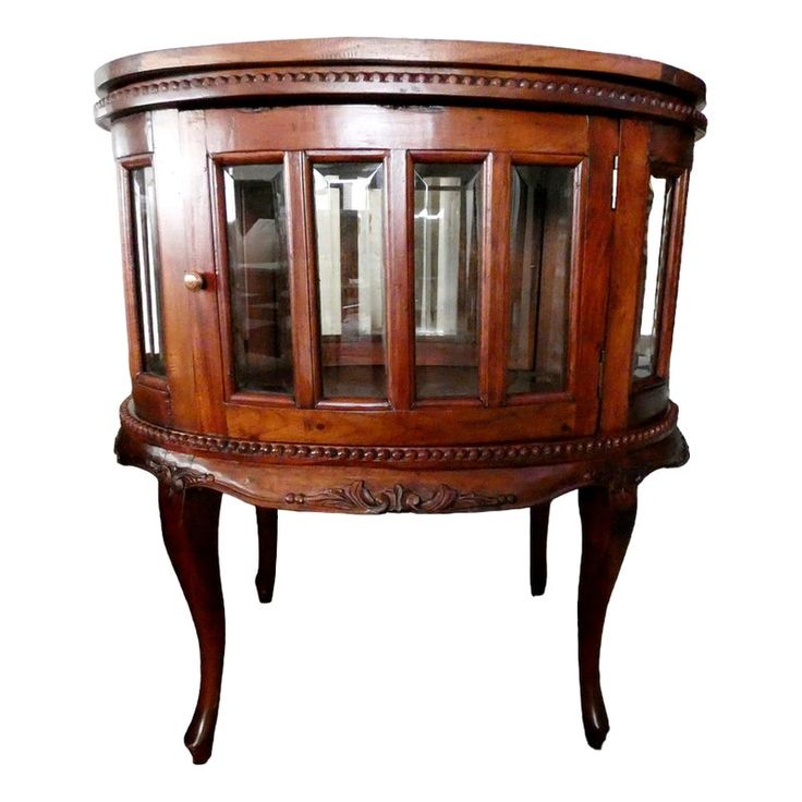 a wooden display cabinet with glass doors on the top and bottom shelves, in an ornate style