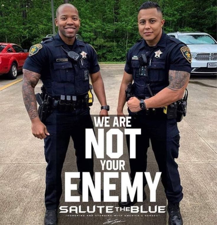 two police officers standing next to each other with the words we are not your enemy