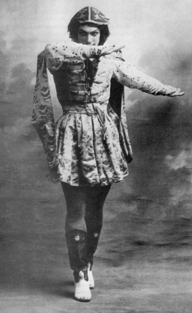 an old photo of a woman dressed in costume