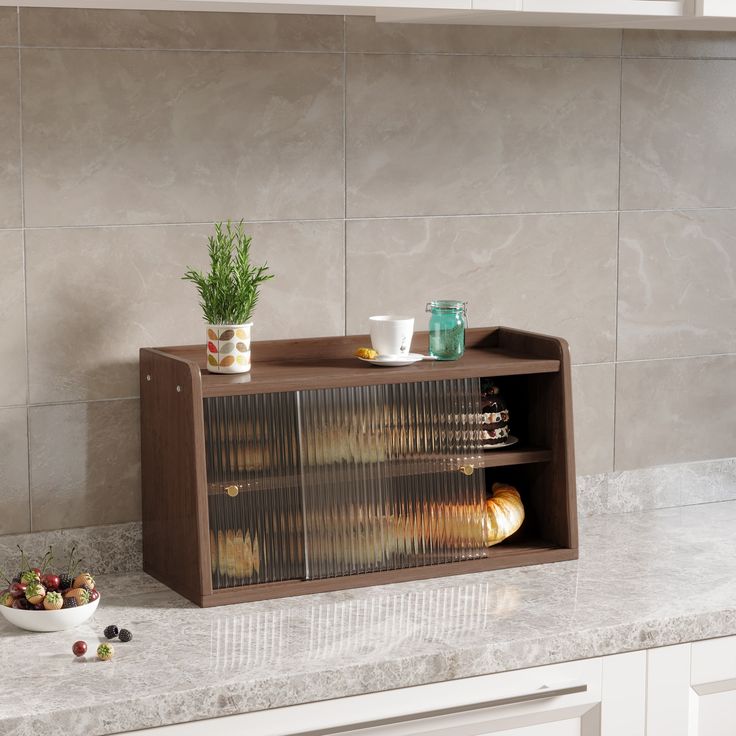 a kitchen counter with some food on it and a potted plant in the corner