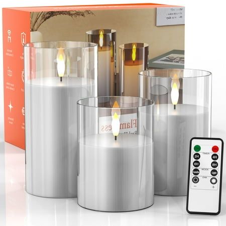 candles and remotes are sitting in front of a box with an orange label on it