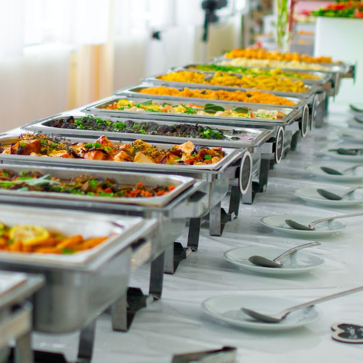 many trays of food are lined up on a table with utensils and spoons