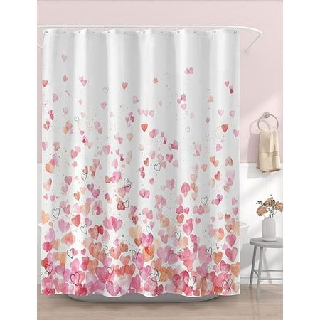 a shower curtain with hearts on it in pink and white colors, next to a bath tub