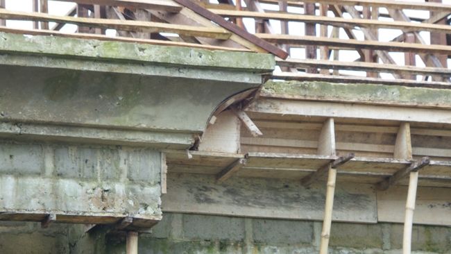 an unfinished building with wooden beams and wood slats